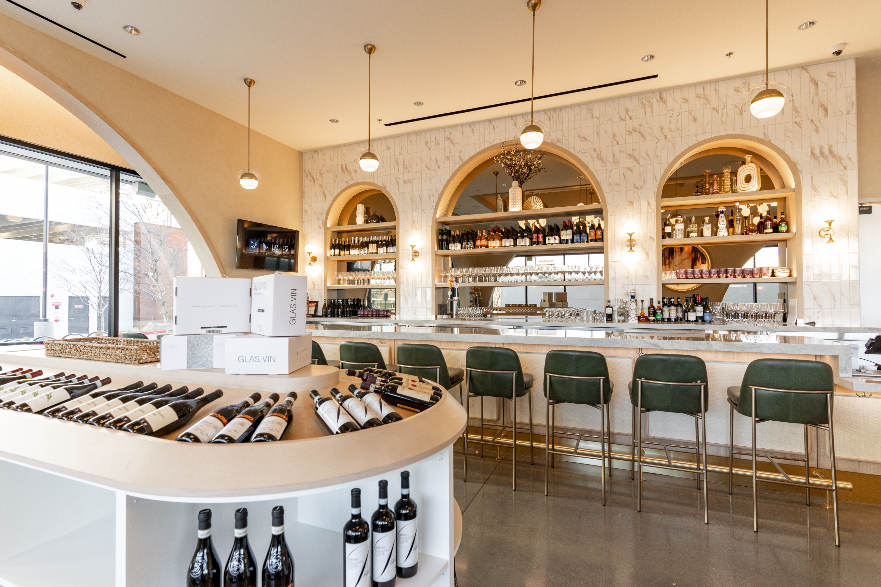 A display of wine bottles in front of s tasting table.