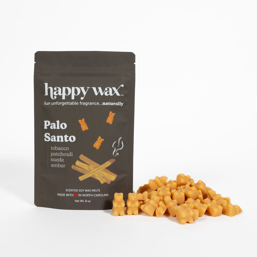 Brown Happy Wax pouch of Palo Santo wax melts with golden wax chunks displayed in front.