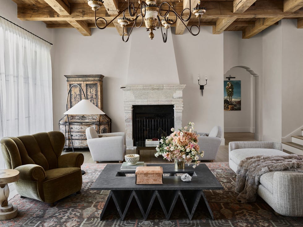 Modern living room featuring a fireplace  decorative furniture  and floral arrangement