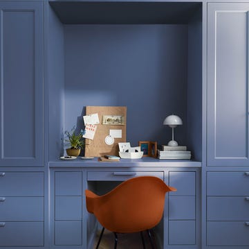 a chair in a room with white cabinets