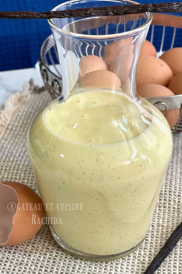 a glass pitcher filled with dressing next to eggs