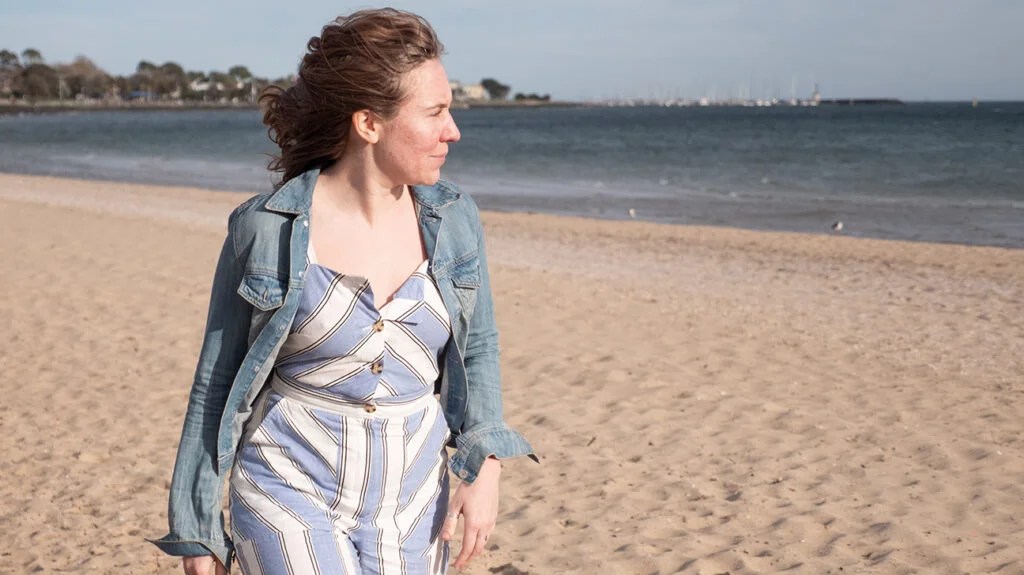 A female walking along a beach