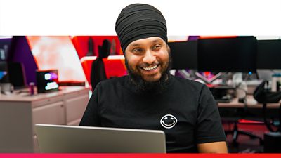 BBC colleague working on a laptop in an office