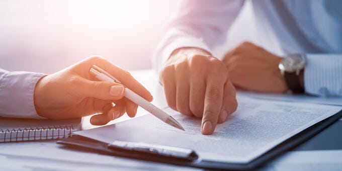 a person writing on a piece of paper